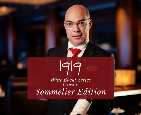 image of sommelier holding a bottle that reads 1919 Wine Event Series ...