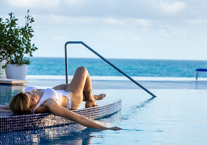 woman lounging by the pool